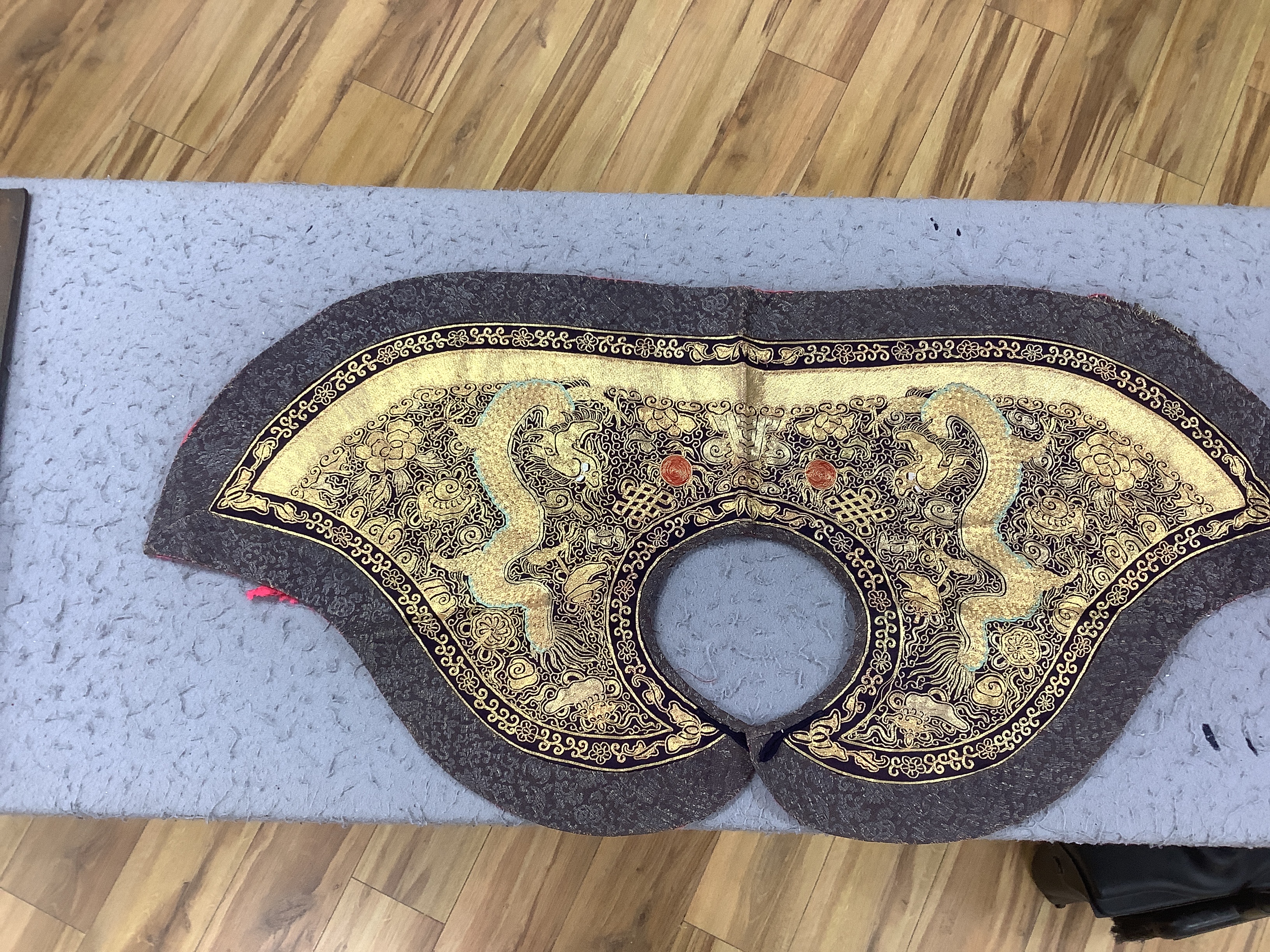Two mid 20th century Chinese embroidered Rank Badges, a large gold thread dragon embroidered collar, three Chinese embroidered panels and a Japanese 1930’s Shantung silk dragon embroidered Kimono dressing gown